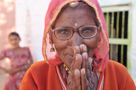 A woman from India with a gesture of thankfulness.